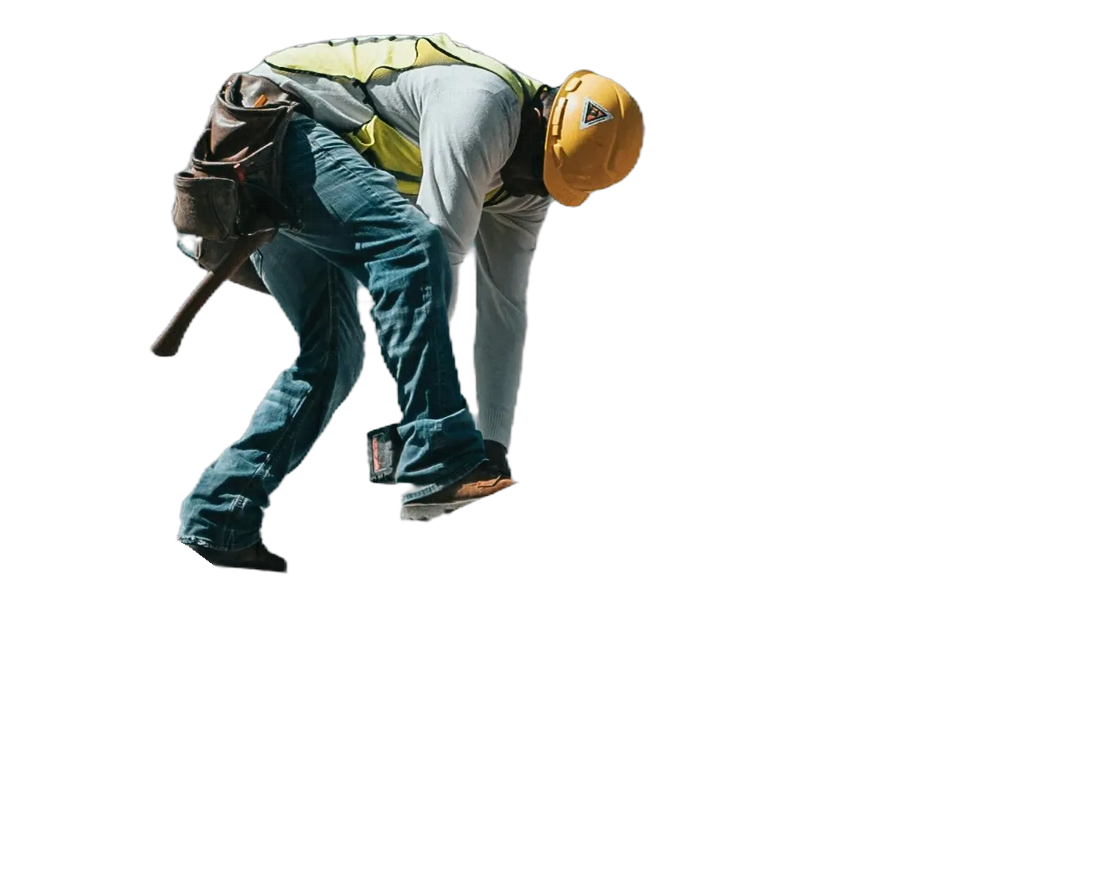 A builder in a hard hat and hi-vis vest working on a timber roof frame against a blue sky