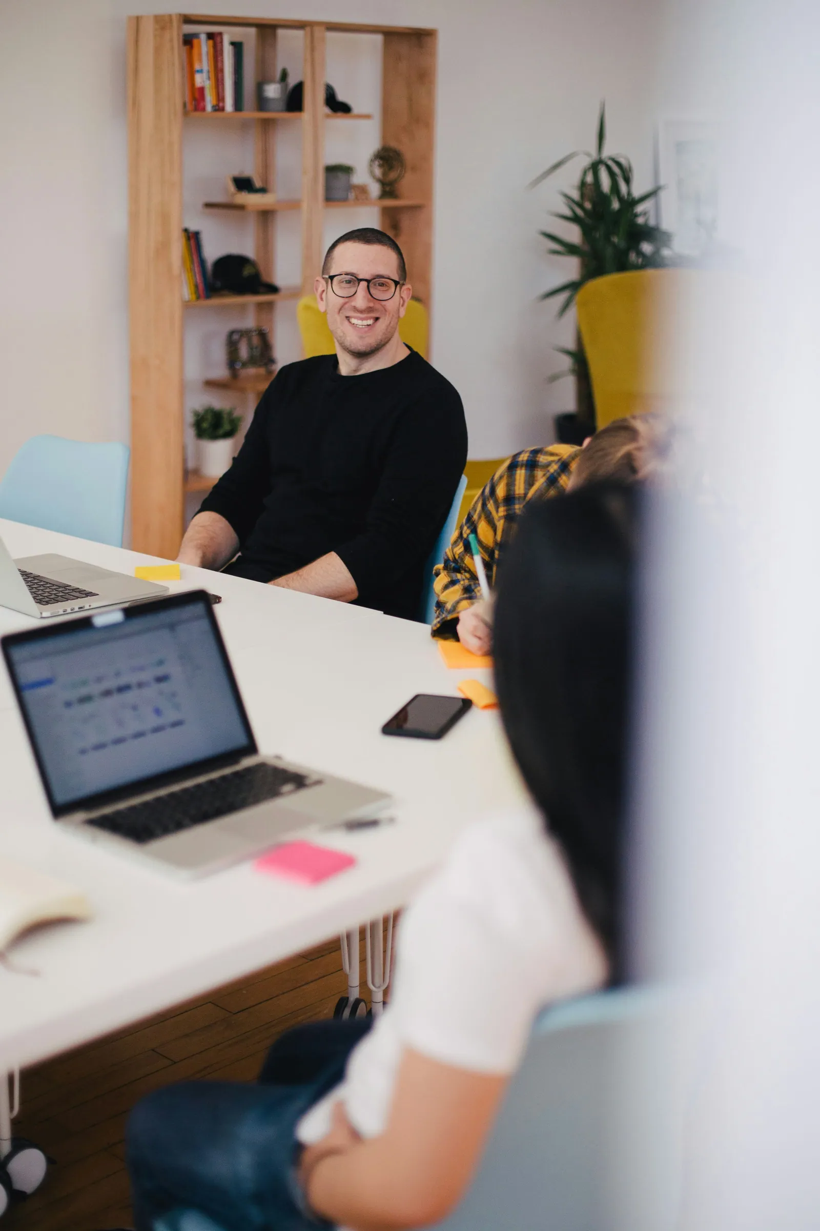 A Smithfield team member smiling at a desk in the studio